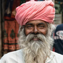 photo of an old Indian man with a gray beard and a turban